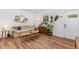 A bright living room featuring hardwood floors, natural light, and a cozy floral sofa at 3649 Guess Rd, Durham, NC 27705