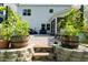 Landscaped backyard with stone steps, barrel planters, and a gravel seating area at 365 Jorpaul Dr, Wake Forest, NC 27587