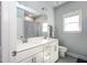 Bright bathroom with a double sink vanity, large mirror, and tiled shower with a patterned curtain at 365 Jorpaul Dr, Wake Forest, NC 27587