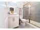Modern bathroom featuring gray tiled shower with glass door and a white vanity at 365 Jorpaul Dr, Wake Forest, NC 27587