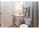 Bright bathroom featuring white vanity, toilet, and gray tiled shower with glass door at 365 Jorpaul Dr, Wake Forest, NC 27587