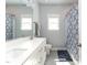 Bathroom features a double sink vanity, white cabinets, and tiled shower with curtain at 365 Jorpaul Dr, Wake Forest, NC 27587