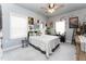 Bright bedroom featuring a ceiling fan, plush carpet, and decoratively adorned walls at 365 Jorpaul Dr, Wake Forest, NC 27587