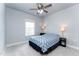 Serene bedroom with a ceiling fan, plush carpet, and natural light from the window at 365 Jorpaul Dr, Wake Forest, NC 27587