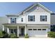 Charming two-story home with white siding, a covered porch, and a two-car garage at 365 Jorpaul Dr, Wake Forest, NC 27587