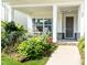 Charming front porch with rocking chairs and lush landscaping at front of house at 365 Jorpaul Dr, Wake Forest, NC 27587