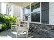 Covered front porch featuring rocking chairs, decorative stone, and lovely views at 365 Jorpaul Dr, Wake Forest, NC 27587