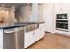Charming kitchen featuring a stainless steel farmhouse sink and white cabinetry at 365 Jorpaul Dr, Wake Forest, NC 27587