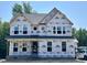 New two-story home with brick foundation and large windows during the construction phase at 386 Rising Star Dr, Clayton, NC 27520
