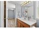 Bright bathroom with a single sink vanity and a view into the laundry room at 408 N Fourth/ 4Th St, Mebane, NC 27302