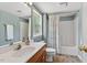 Full bathroom with wooden vanity, white sink, shower and tub combo, and window at 408 N Fourth/ 4Th St, Mebane, NC 27302