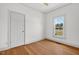 This is a bedroom with hardwood floors, one window with view, one closet door and white walls at 408 N Fourth/ 4Th St, Mebane, NC 27302