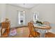 A dining area with wood floors, a white dining table, natural light, and wooden hutch at 408 N Fourth/ 4Th St, Mebane, NC 27302