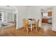 A dining area with wood floors, a white dining table, and views to a kitchen at 408 N Fourth/ 4Th St, Mebane, NC 27302
