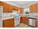 A kitchen with oak cabinets, white appliances, a tile backsplash, and natural light at 408 N Fourth/ 4Th St, Mebane, NC 27302