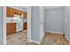 Kitchen flows into laundry room with oak cabinets and bright white appliances at 408 N Fourth/ 4Th St, Mebane, NC 27302