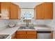 The kitchen sink with bright window, light countertops, and oak cabinets at 408 N Fourth/ 4Th St, Mebane, NC 27302