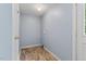 This is a laundry room featuring blue walls and tile flooring, a back door, and a closet at 408 N Fourth/ 4Th St, Mebane, NC 27302