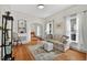 Bright living room with hardwood floors, neutral tones, large windows, and decorative shelving at 408 N Fourth/ 4Th St, Mebane, NC 27302