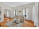 Sunlit living room with hardwood floors, a comfortable sofa, and stylish decor creating a warm atmosphere at 408 N Fourth/ 4Th St, Mebane, NC 27302