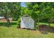 Functional storage shed nestled among trees, providing ample outdoor storage space at 408 N Fourth/ 4Th St, Mebane, NC 27302
