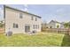 A cozy backyard featuring a small patio set, grassy area, and a well-maintained fence at 418 Magna Dr, Durham, NC 27703