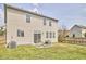 A cozy backyard featuring a small patio set, grassy area, and a well-maintained fence at 418 Magna Dr, Durham, NC 27703