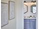 Stylish bathroom featuring a blue vanity with double sinks and decorative hexagonal mirrors at 418 Magna Dr, Durham, NC 27703