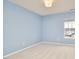 Empty blue bedroom with plush carpet and bright window offering neighbourhood views at 418 Magna Dr, Durham, NC 27703
