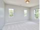Bright, neutral bedroom with carpeted floors and plenty of natural light from the double windows at 418 Magna Dr, Durham, NC 27703
