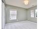 Neutral bedroom with large windows and carpet provides a cozy, adaptable space at 418 Magna Dr, Durham, NC 27703