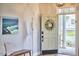 Stylish entryway with a decorated front door, bench, and ocean-themed artwork at 418 Magna Dr, Durham, NC 27703