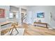 Entryway with light-colored floors, a bench with pillows, and view to open stairs and kitchen at 418 Magna Dr, Durham, NC 27703