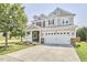 Charming two-story home with well-maintained lawn and an attached two-car garage at 418 Magna Dr, Durham, NC 27703