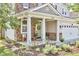 Charming front porch with stone accents, decorative plants, and a welcoming bench at 418 Magna Dr, Durham, NC 27703