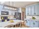 Stylish kitchen features blue cabinets, stainless steel appliances, and a large island with pendant lighting at 418 Magna Dr, Durham, NC 27703