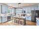 Well-appointed kitchen with stainless steel appliances, quartz countertops, and island seating at 418 Magna Dr, Durham, NC 27703