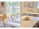 Bright kitchen island features a granite countertop and seating, plus sliding glass doors at 418 Magna Dr, Durham, NC 27703