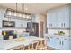 Stylish kitchen features blue cabinets, stainless steel appliances, and a large island with pendant lighting at 418 Magna Dr, Durham, NC 27703