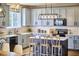 Updated kitchen featuring sleek gray cabinets, a center island with seating, and modern appliances at 418 Magna Dr, Durham, NC 27703