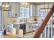 Bright kitchen with gray cabinets, white countertops, and stylish fixtures, plus a view into the dining area at 418 Magna Dr, Durham, NC 27703