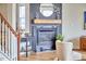 Living area with fireplace and black mantle, plus an adjacent side table and view of the staircase at 418 Magna Dr, Durham, NC 27703