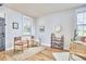 Bright living area with two arm chairs, a small book shelf, and light-colored wood flooring at 418 Magna Dr, Durham, NC 27703