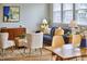 Stylish living room featuring a blue sofa, accent chairs, and modern art on the wall at 418 Magna Dr, Durham, NC 27703