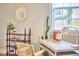 Comfortable home office showcasing a desk with cactus decor, a stylish chair, and natural light from the window at 418 Magna Dr, Durham, NC 27703