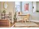 Stylish home office with a modern desk, woven chair, decorative shelving, and natural light from the window at 418 Magna Dr, Durham, NC 27703