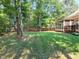 Spacious, well-maintained backyard with lush lawn, bordered by mature trees and a wood fence at 4416 Brighton Ridge Dr, Apex, NC 27539