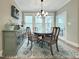 Dining room with dark wood table, seating for four, and a glass door to the outside at 4416 Brighton Ridge Dr, Apex, NC 27539