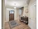 Bright foyer with hardwood floors, elegant light fixture, and a staircase leading to the upper level at 4416 Brighton Ridge Dr, Apex, NC 27539