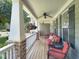 Inviting front porch with comfortable seating, ceiling fan, and hanging flower baskets, perfect for relaxing at 4416 Brighton Ridge Dr, Apex, NC 27539
